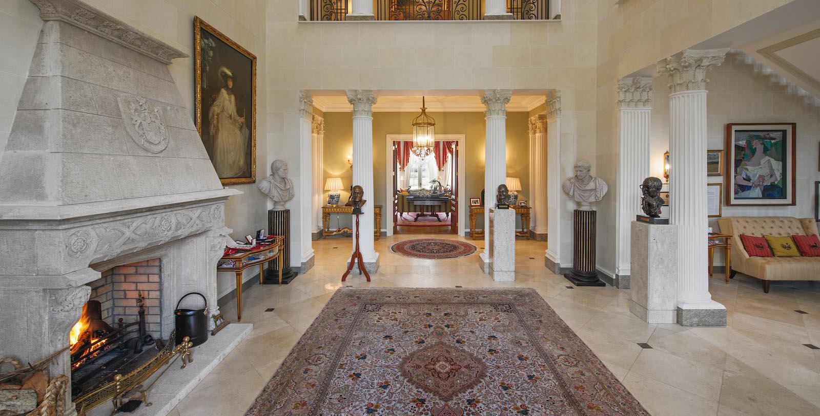 a room with a rug and statues