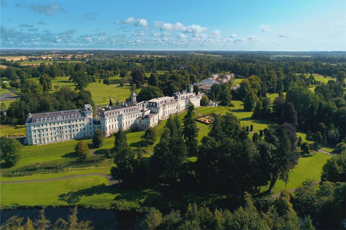 a large white building surrounded by trees