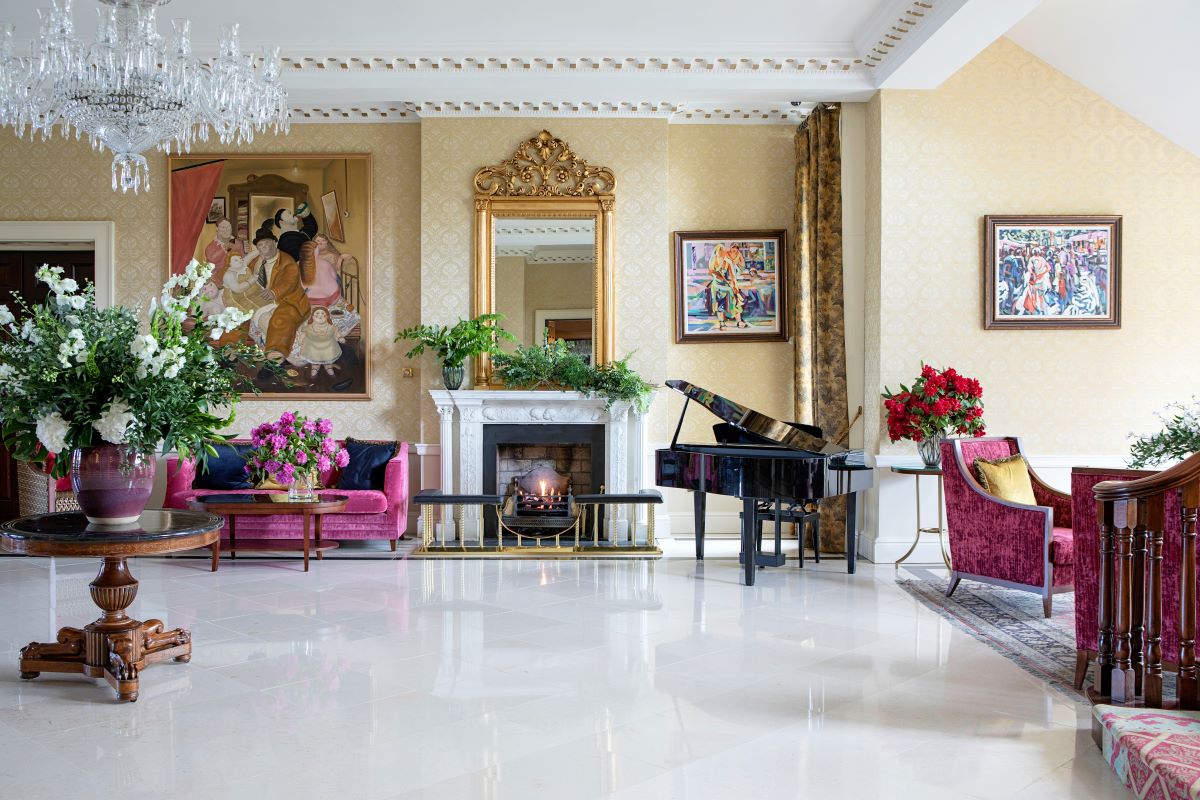 a living room with a piano and a fireplace