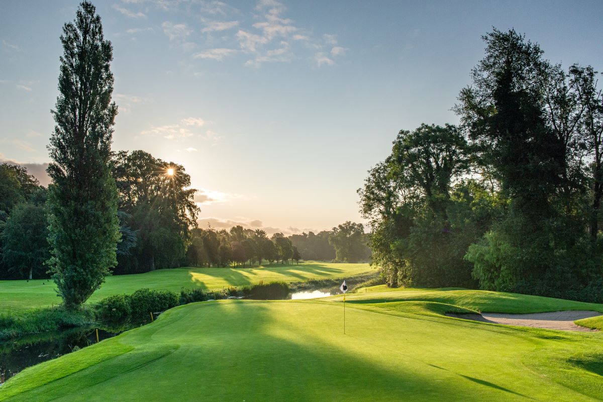 a golf course with a river running through it