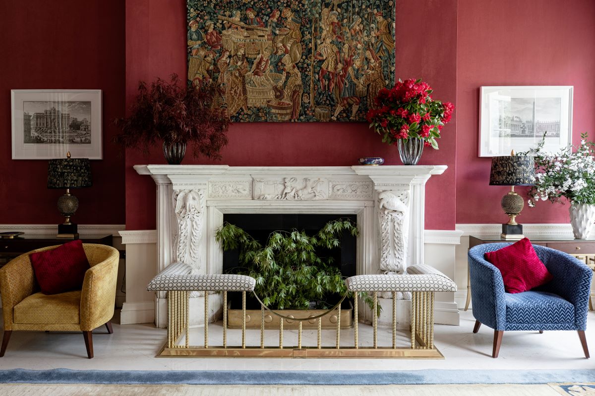 a room with a fireplace and chairs