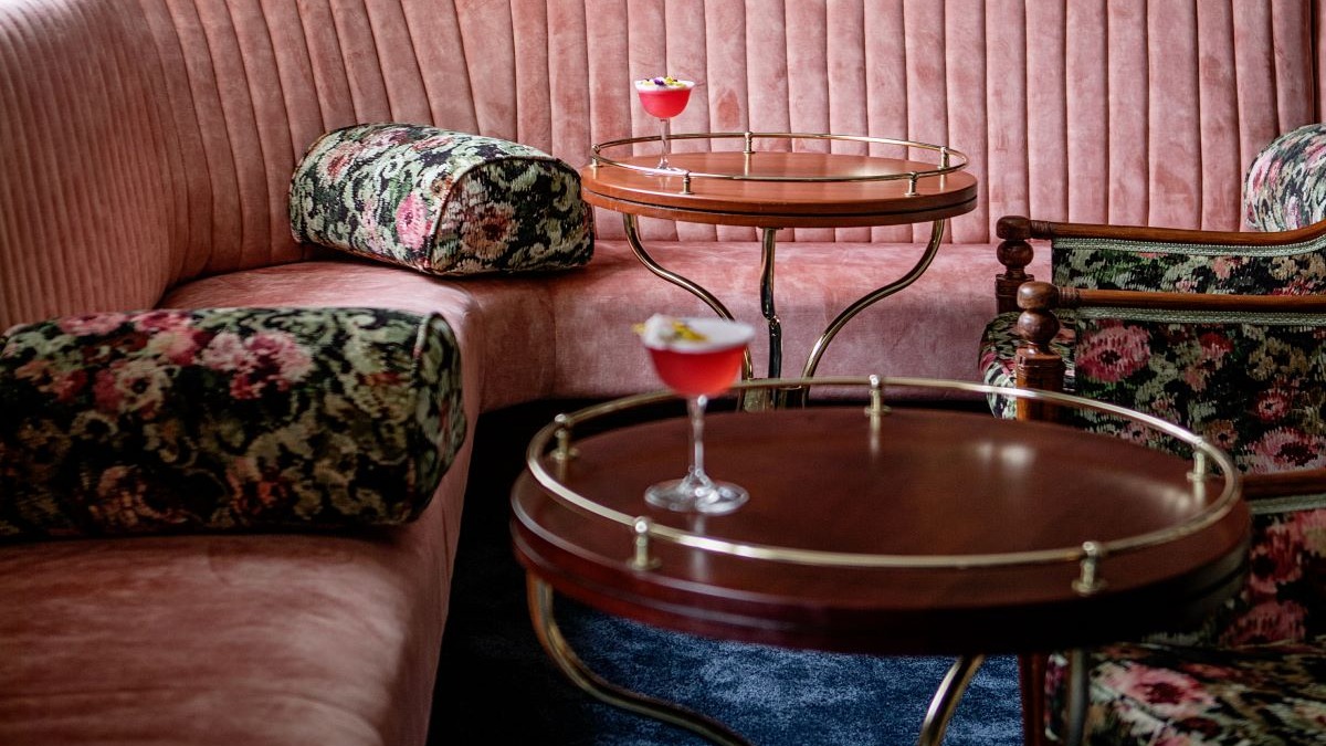 a couch with a table and a couch with a drink on it