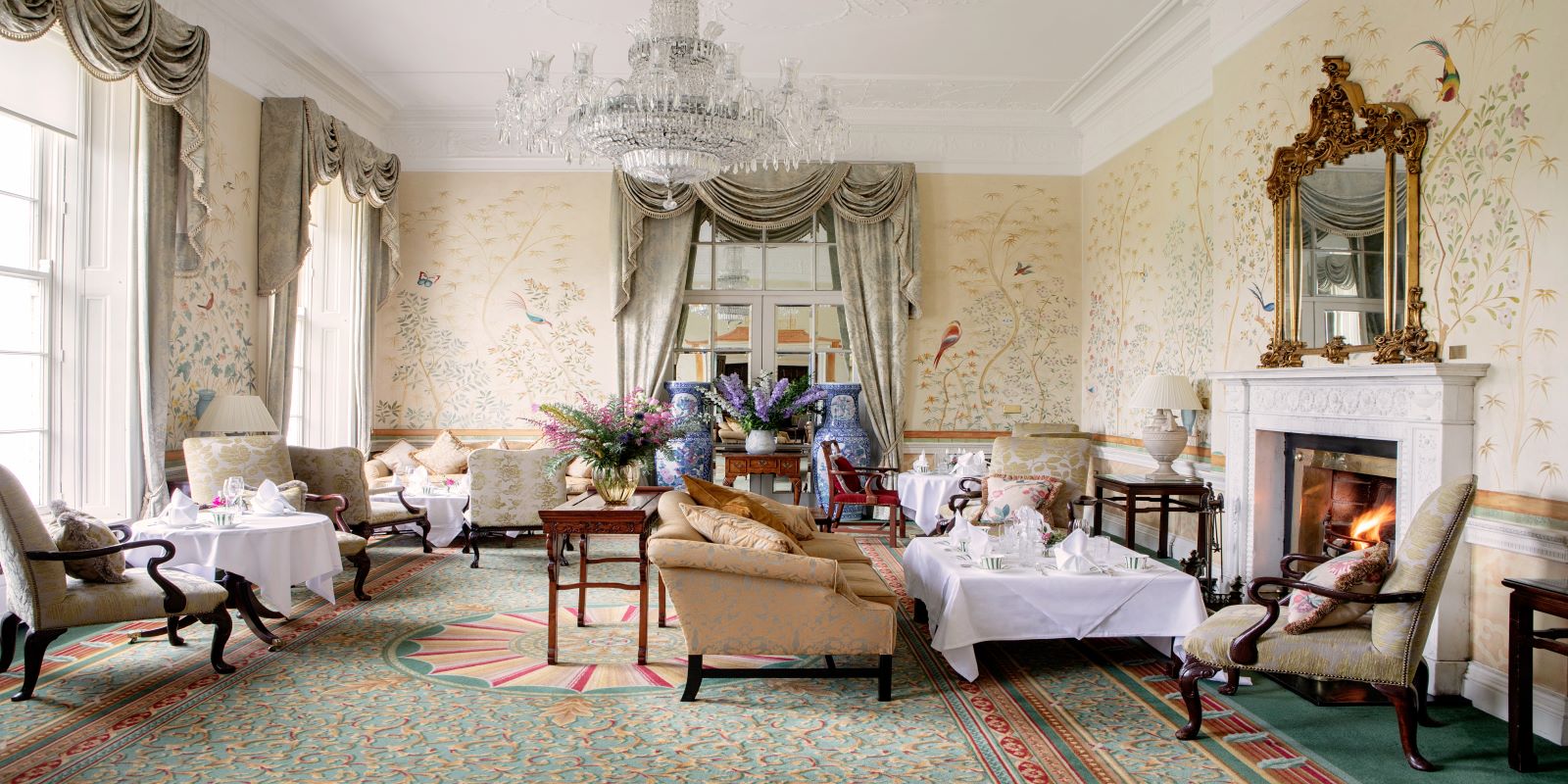 a room with a chandelier and couches