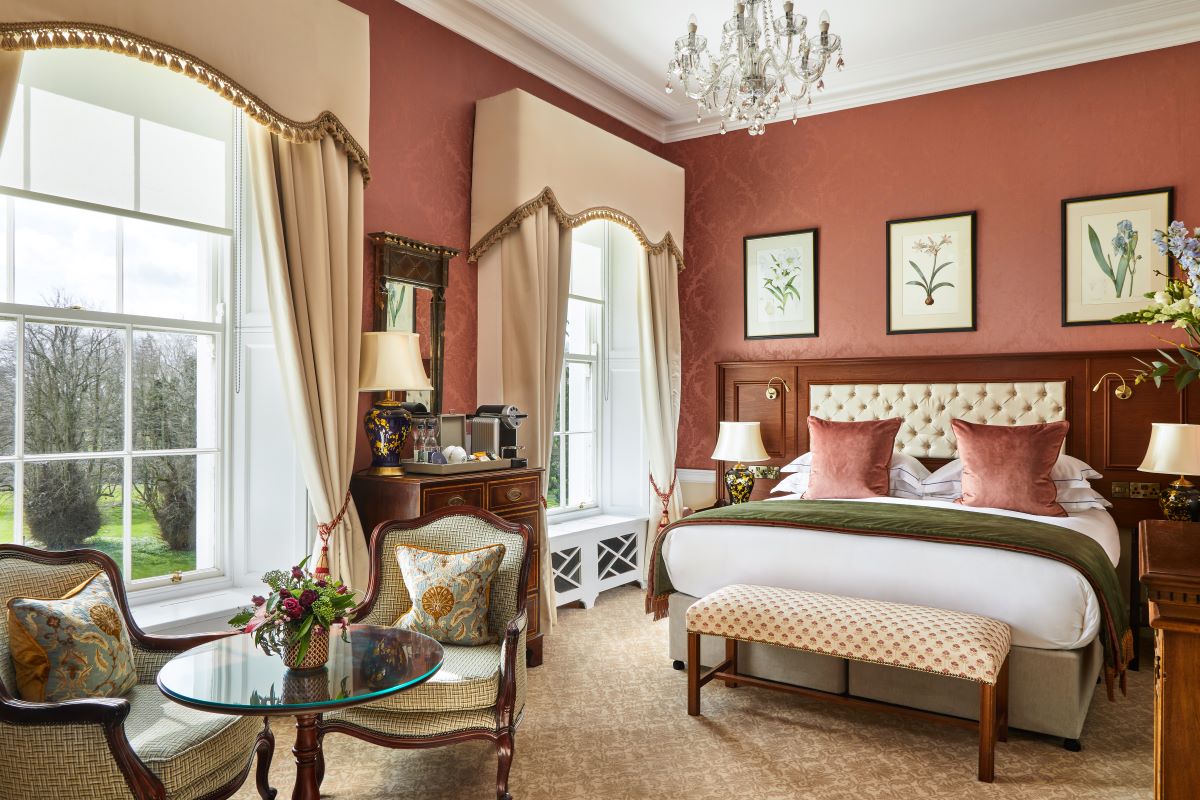 a bedroom with a bed and chairs