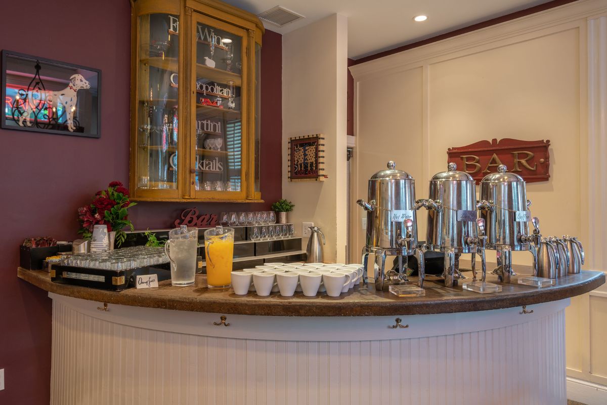 a bar with a counter and drinks