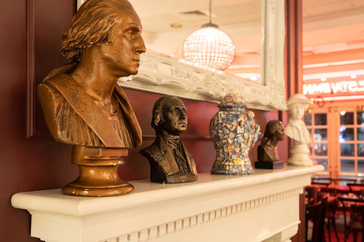 a group of busts on a mantle