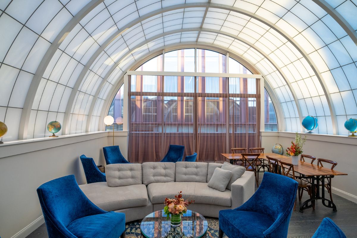 a room with a round table and couches