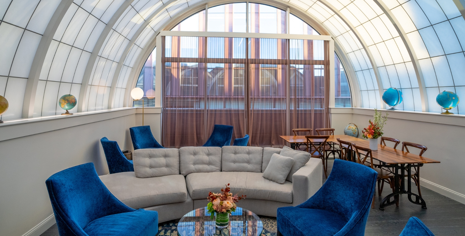 a room with a round table and chairs