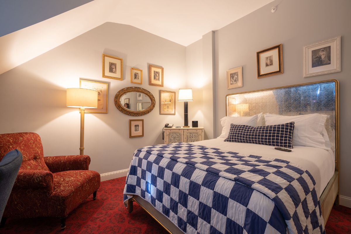 a bedroom with a bed and a chair