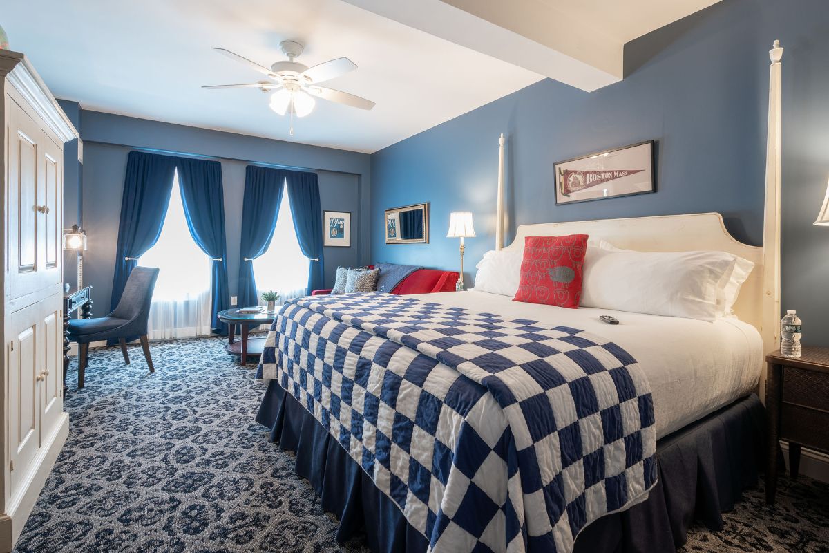 a room with a bed and a ceiling fan
