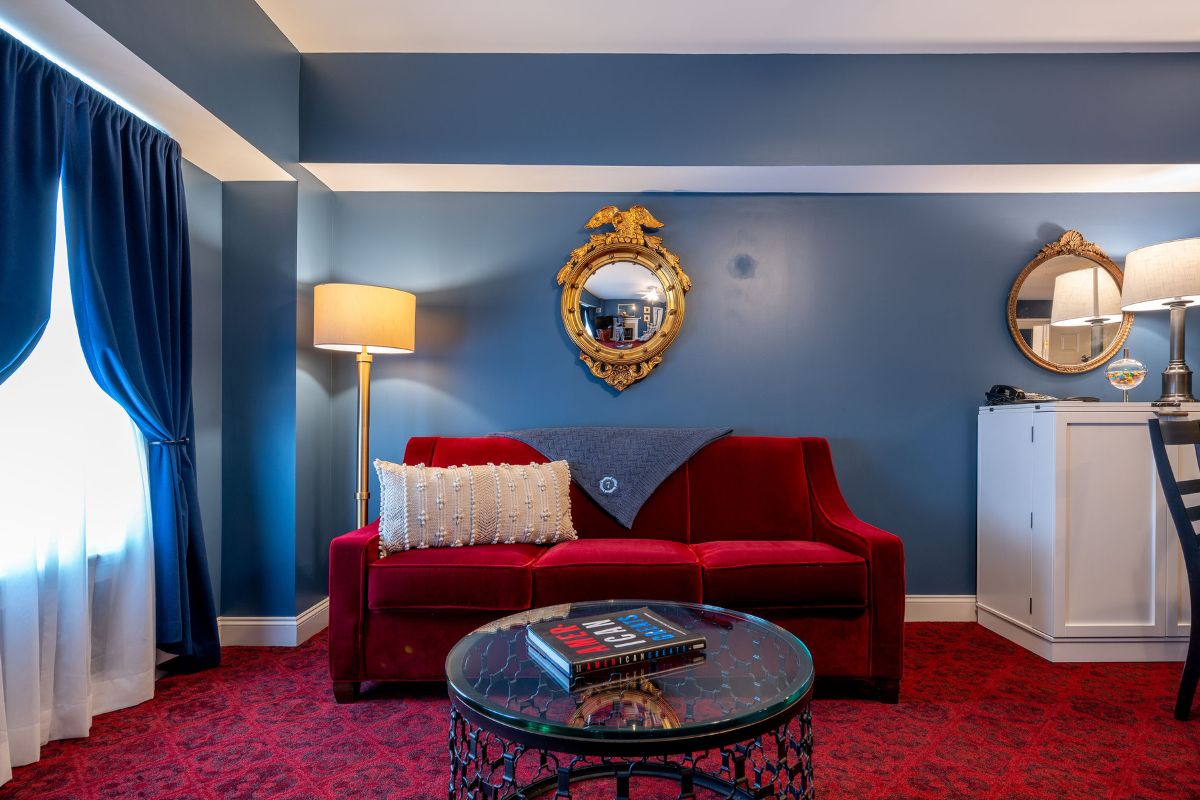 a living room with a red couch and a round table