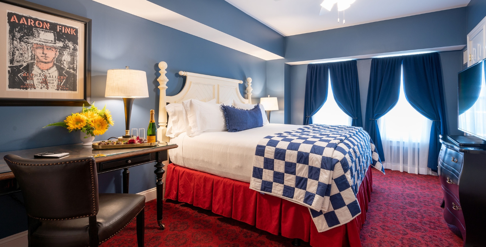 a bed with a red and white bedding