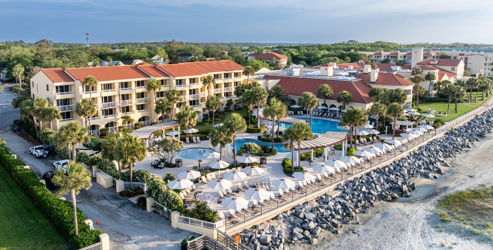 a resort with a pool and palm trees