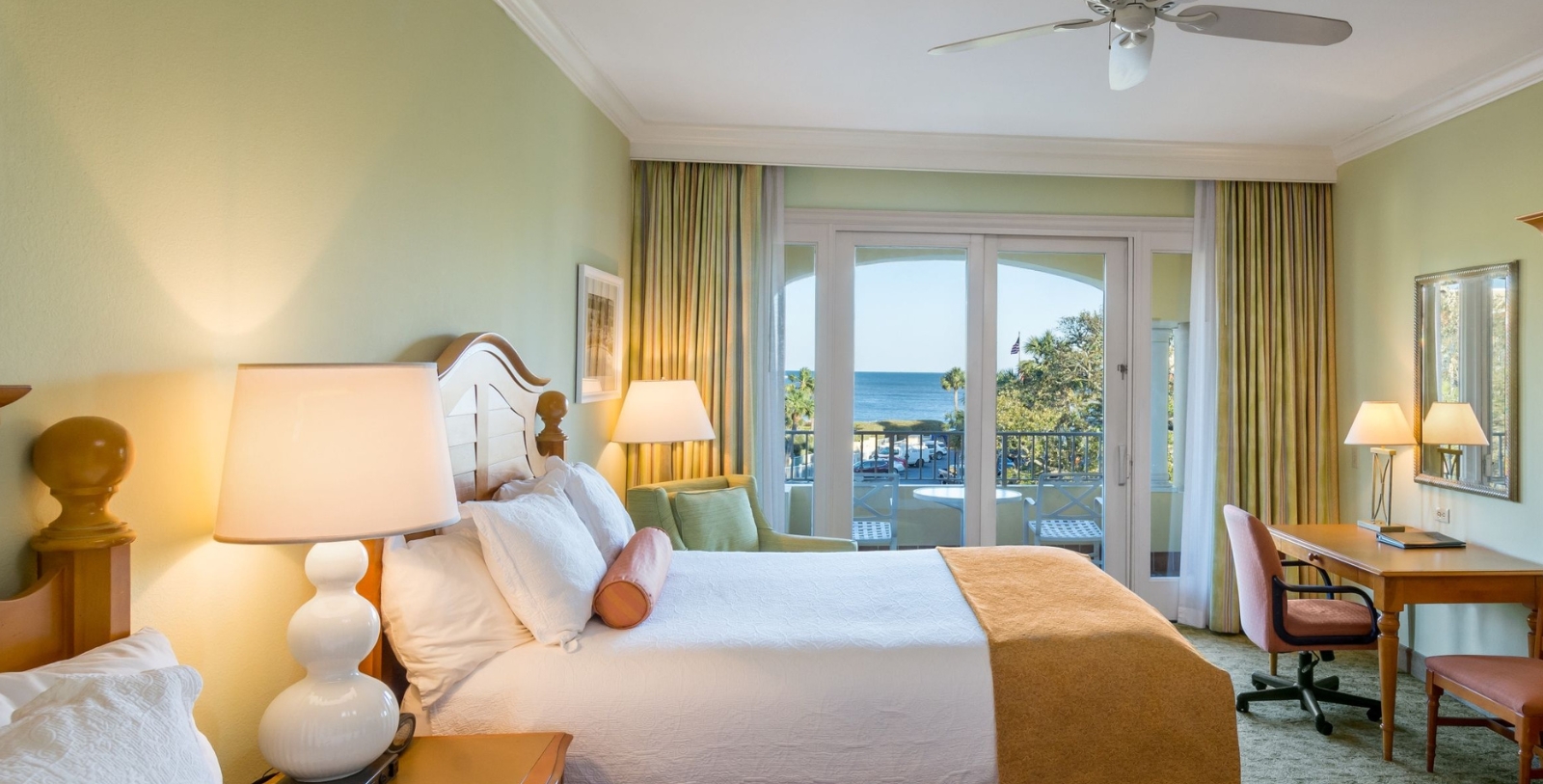a bedroom with a large bed and a glass door
