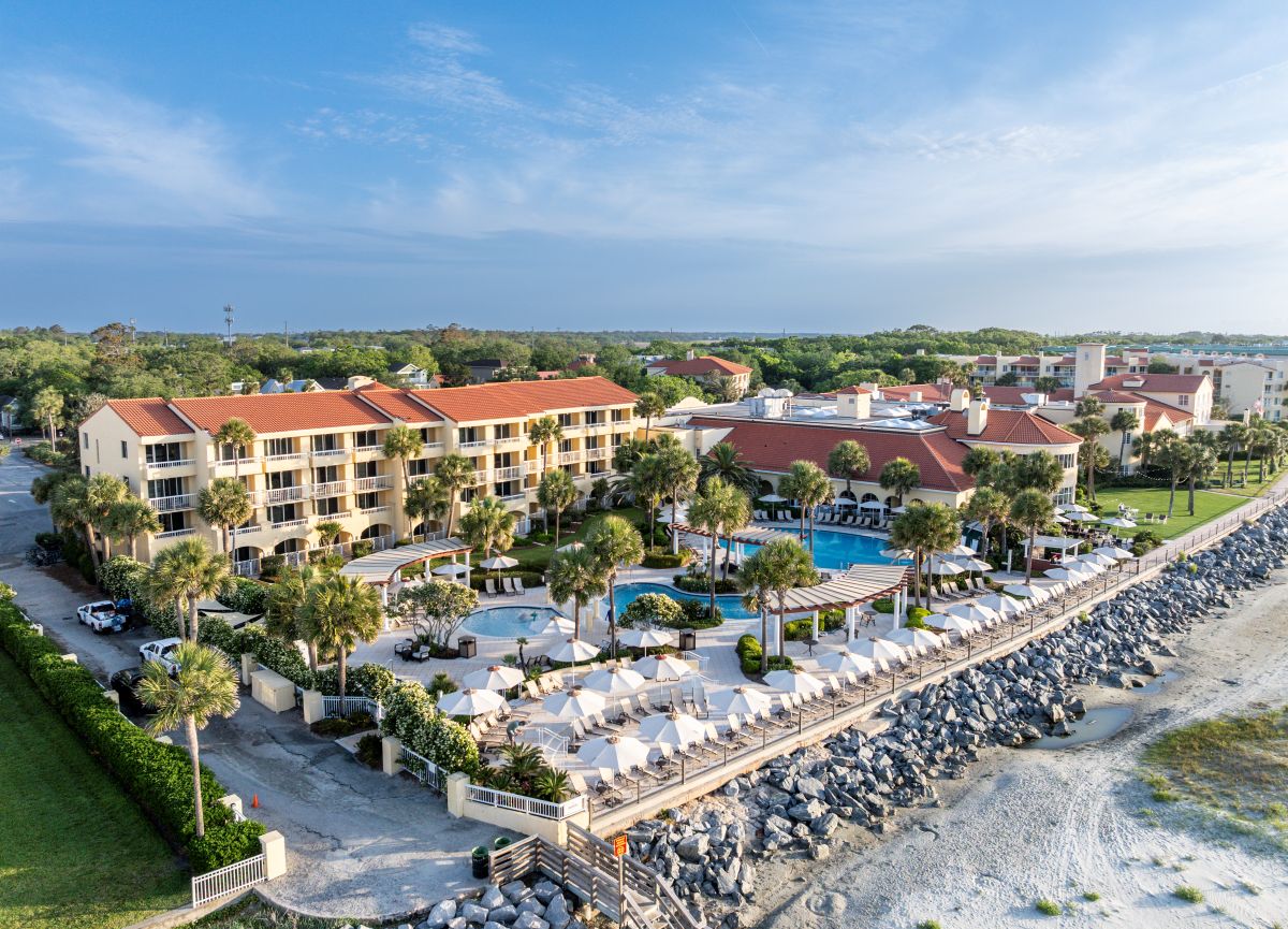 a resort with a pool and palm trees