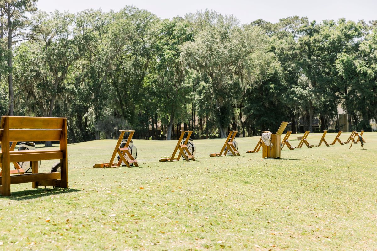 a group of wooden chairs in a field