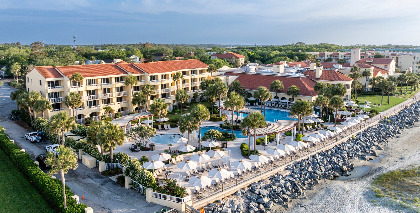 a resort with a pool and palm trees