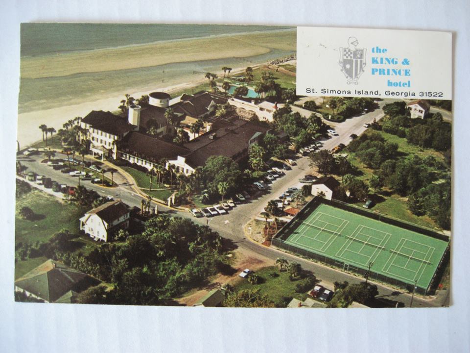 an aerial view of a beach and a tennis court