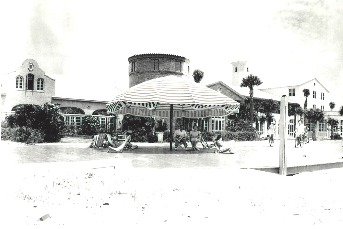people sitting under a striped umbrella