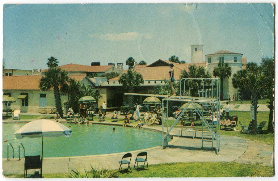 a pool with people sitting and swimming