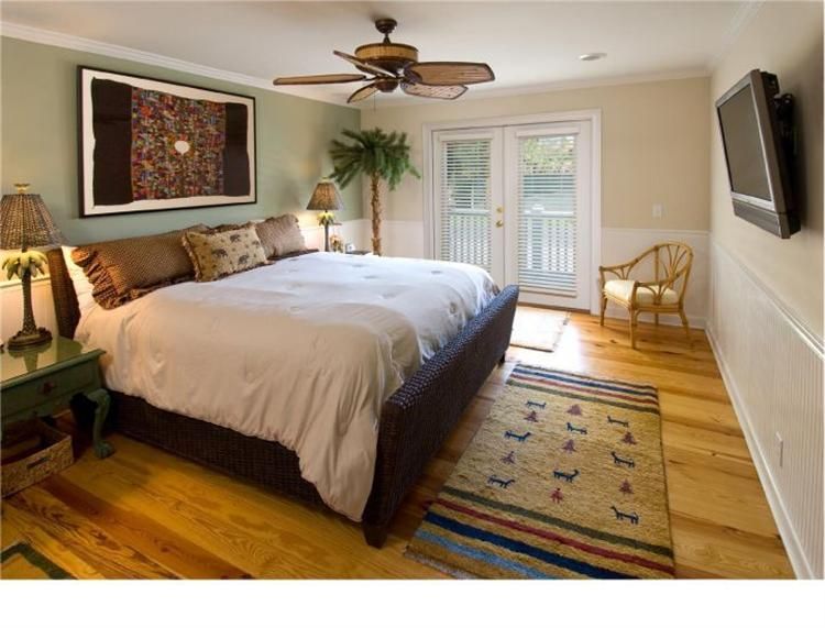 a bedroom with a large bed and a rug