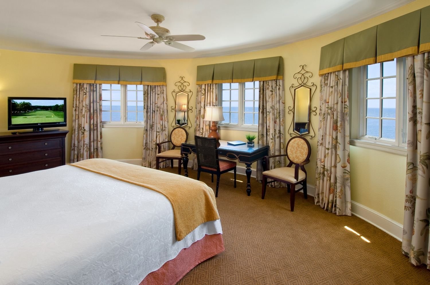 a room with a bed and chairs