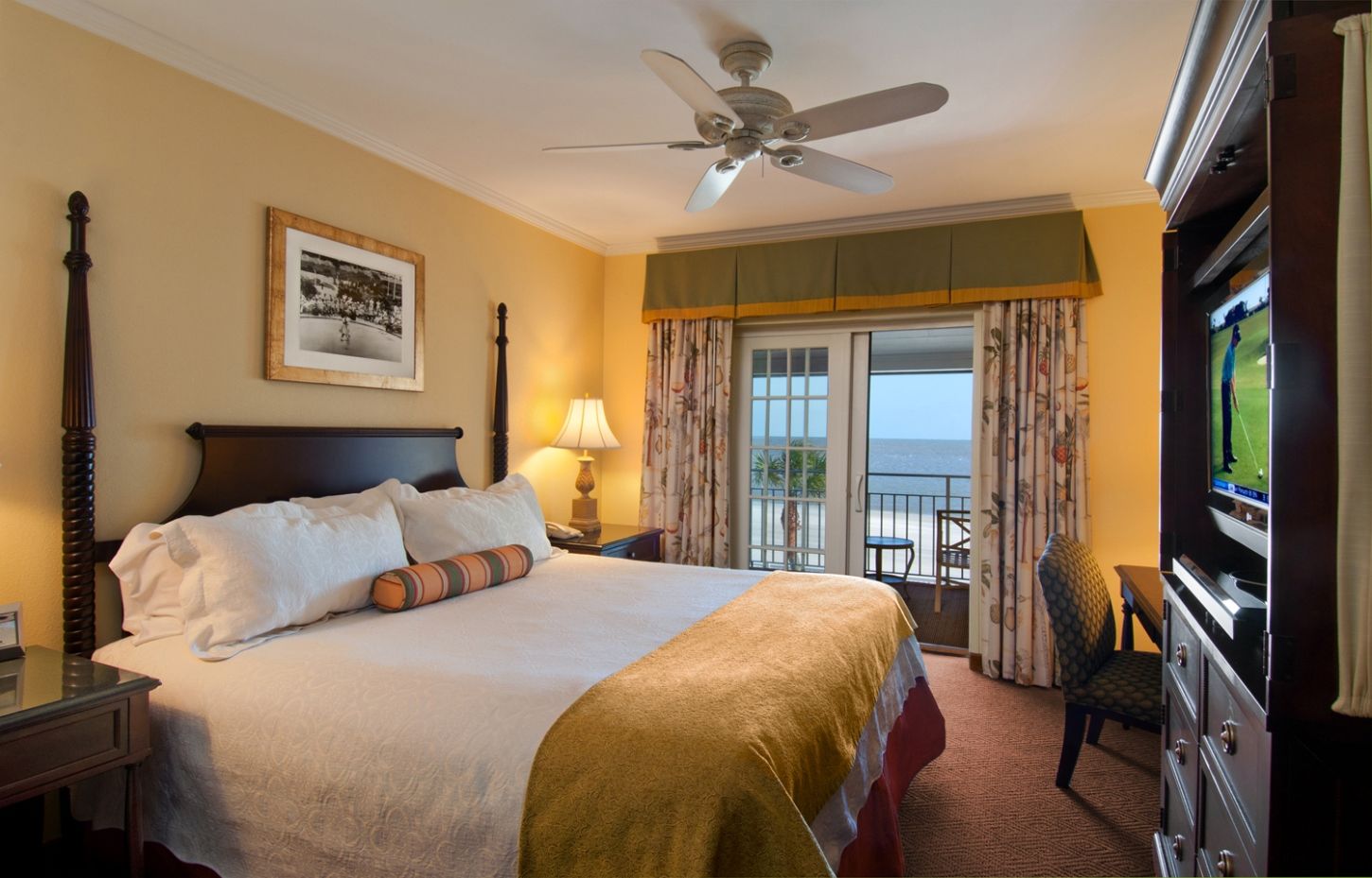 a bedroom with a large bed and a ceiling fan
