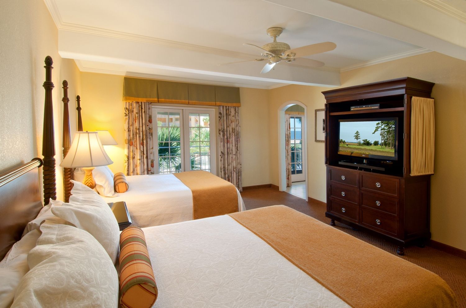 a room with two beds and a television