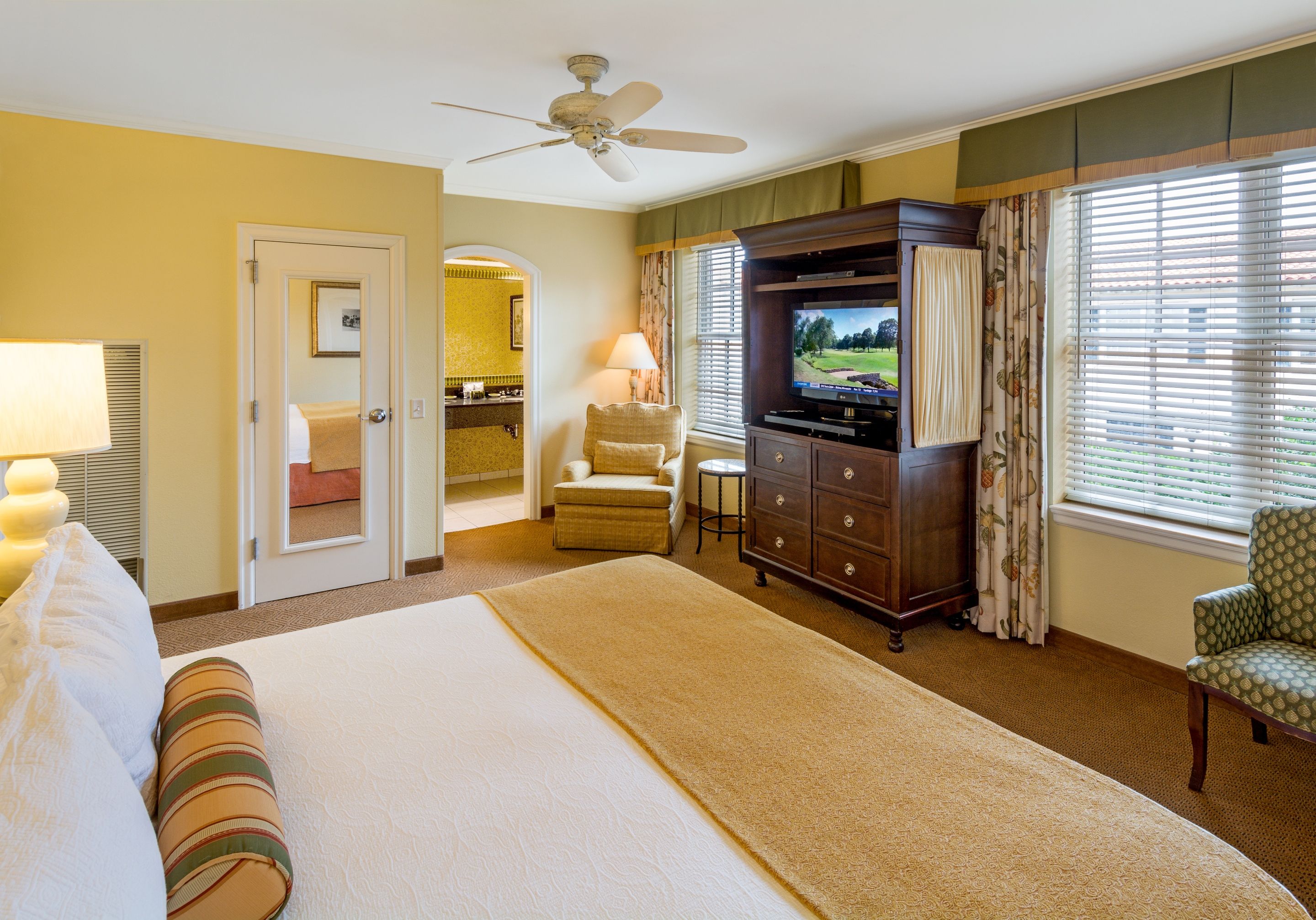 a room with a large bed and a television