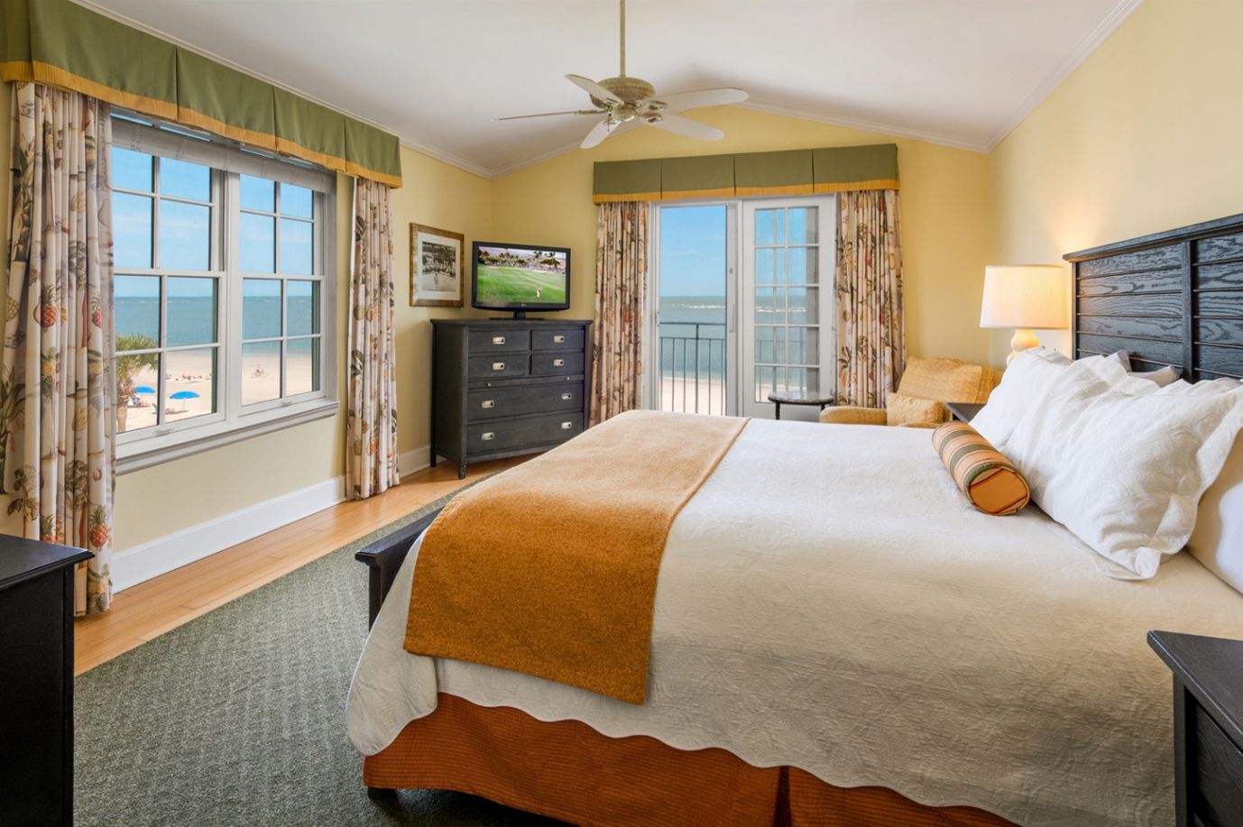 a bedroom with a television and a window