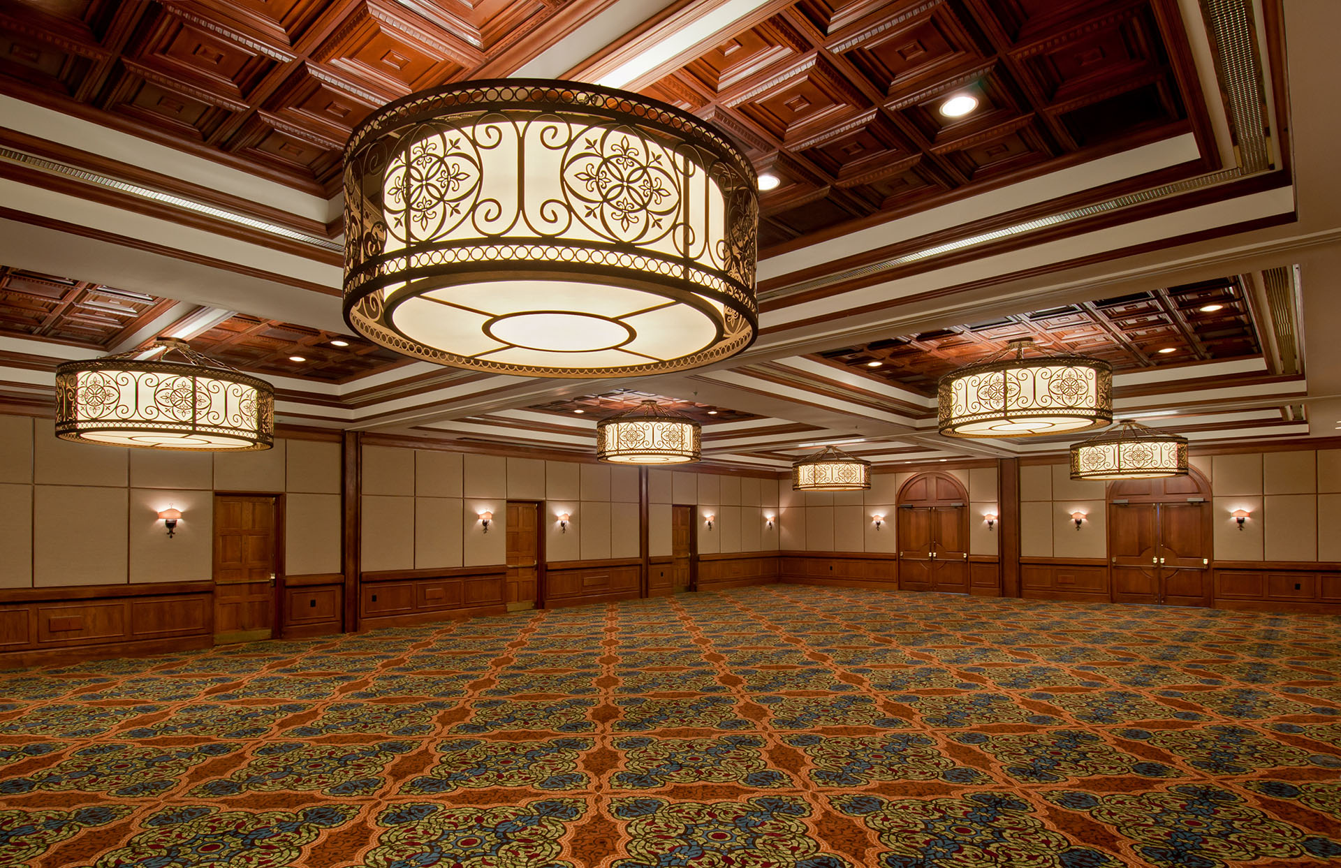 a large room with chandeliers and patterned carpet