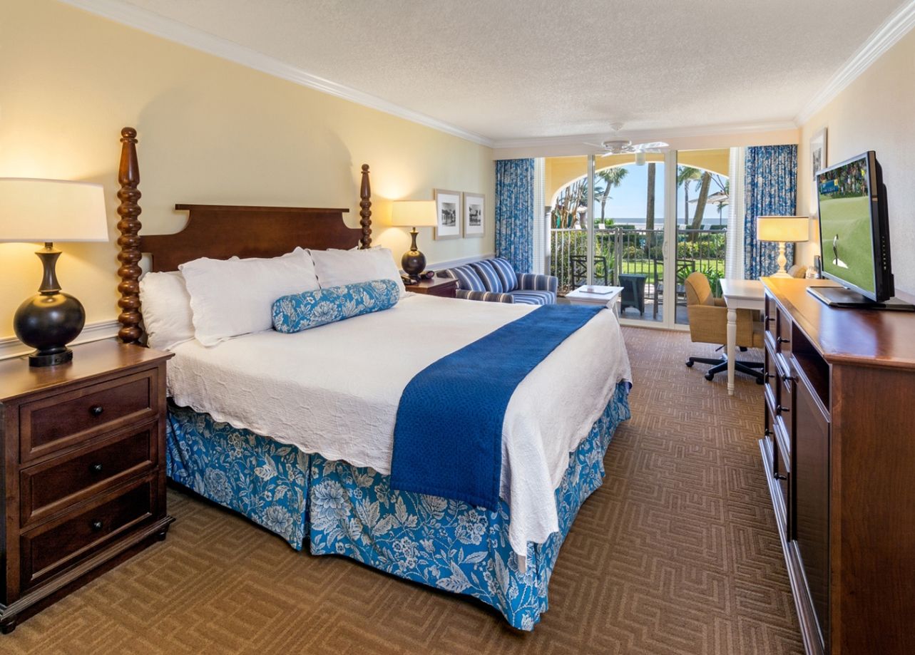 a room with a large bed and a desk