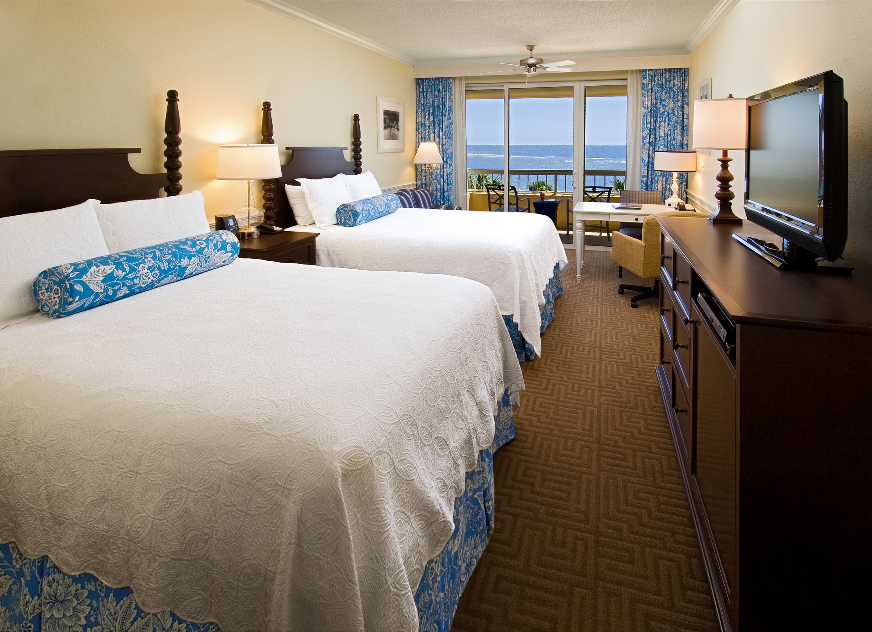 a room with two beds and a window