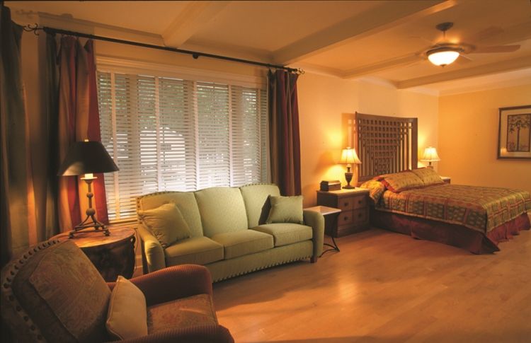 a bedroom with a bed and a couch