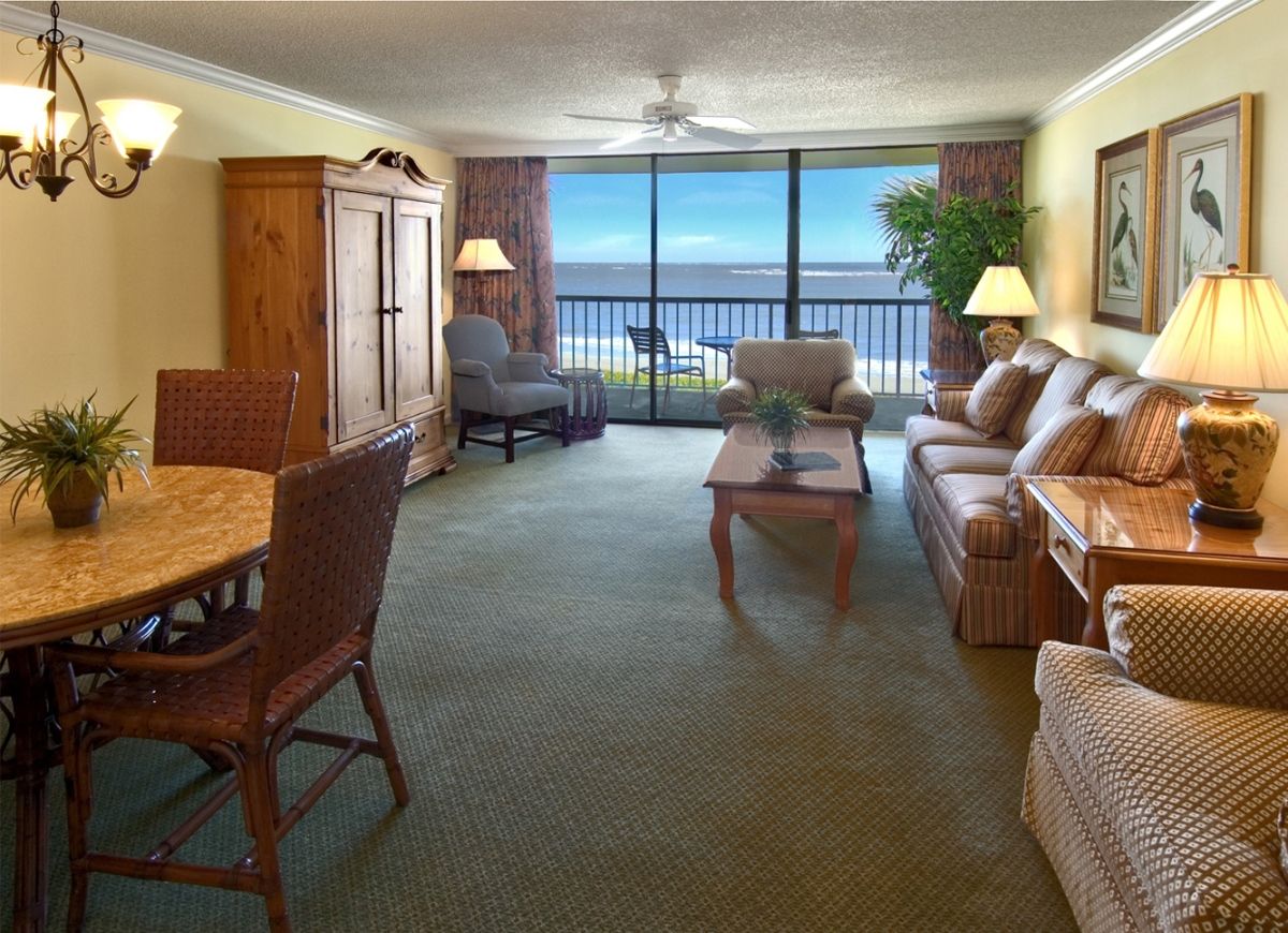 a living room with a view of the ocean