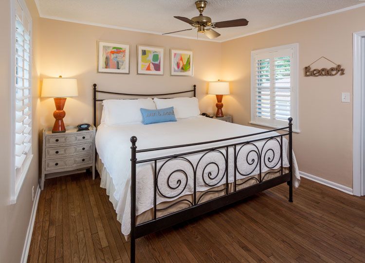 a bedroom with a bed and a fan