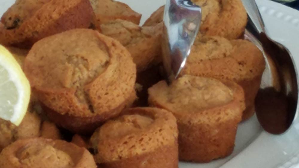 a plate of muffins with a spoon