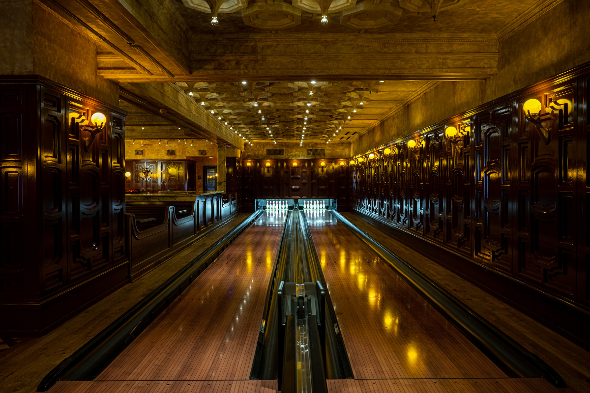 a bowling alley with lights on the ceiling