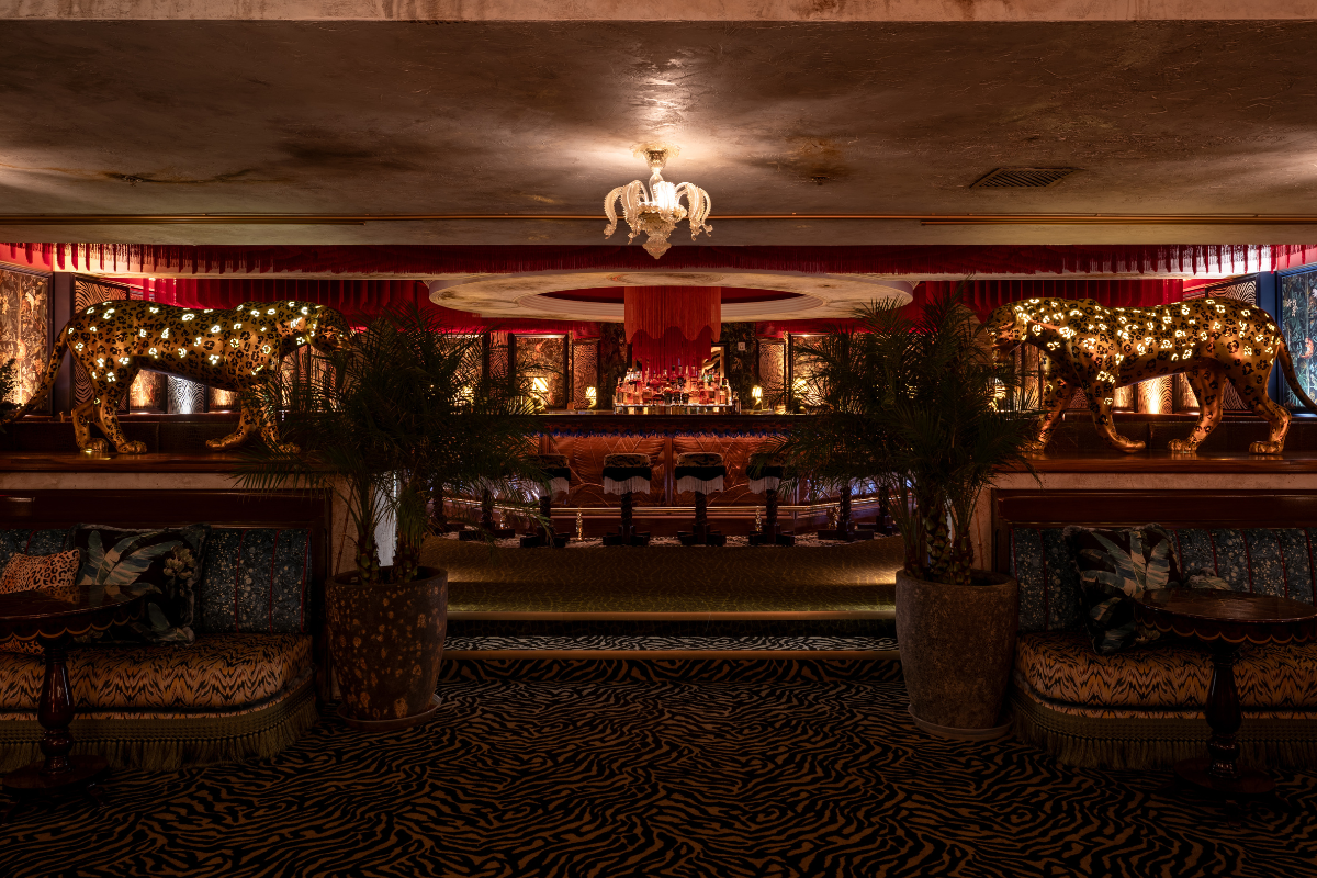 a room with a bar and chairs