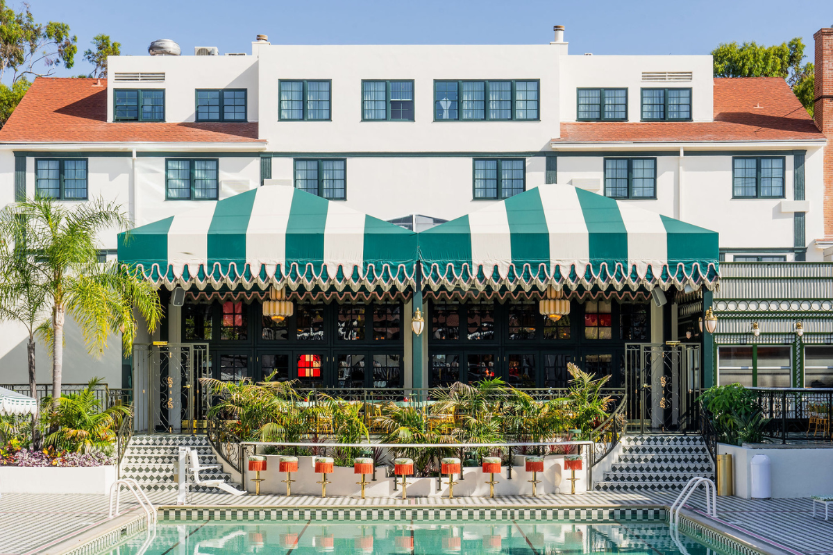 a pool with a green and white striped awning