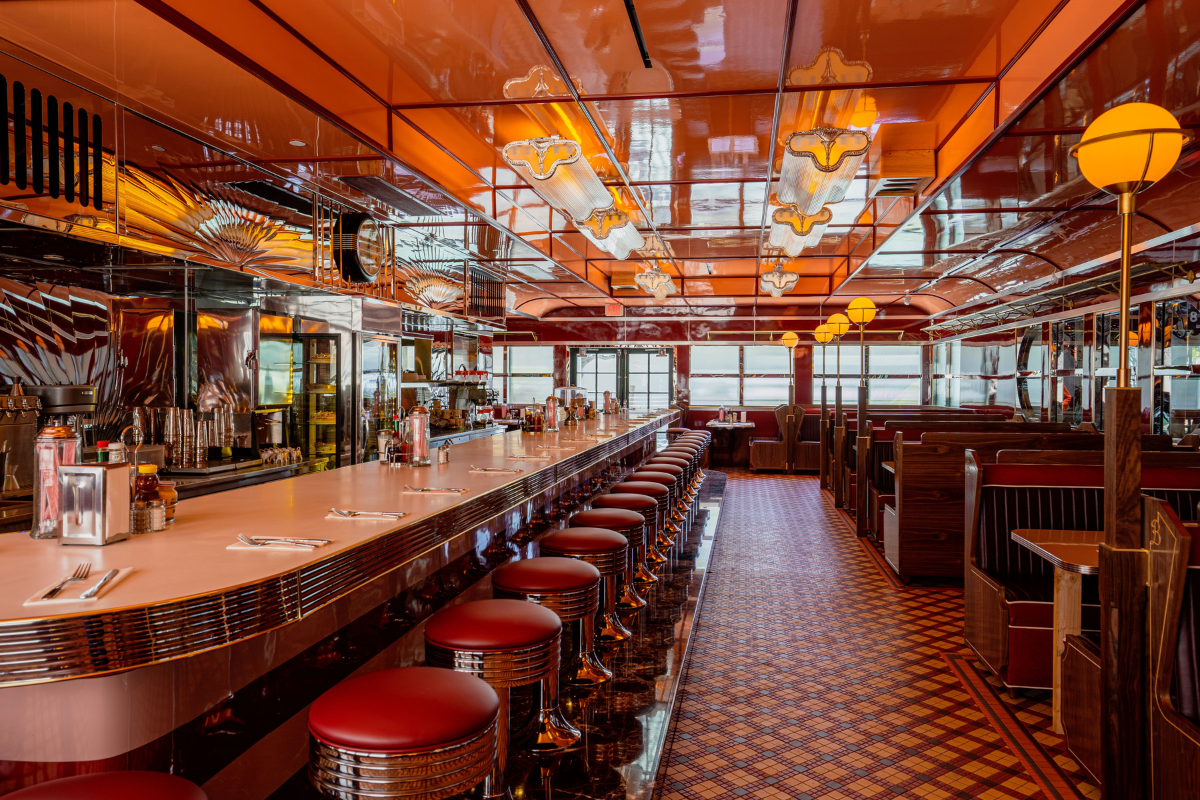 a long bar with stools and a row of stools