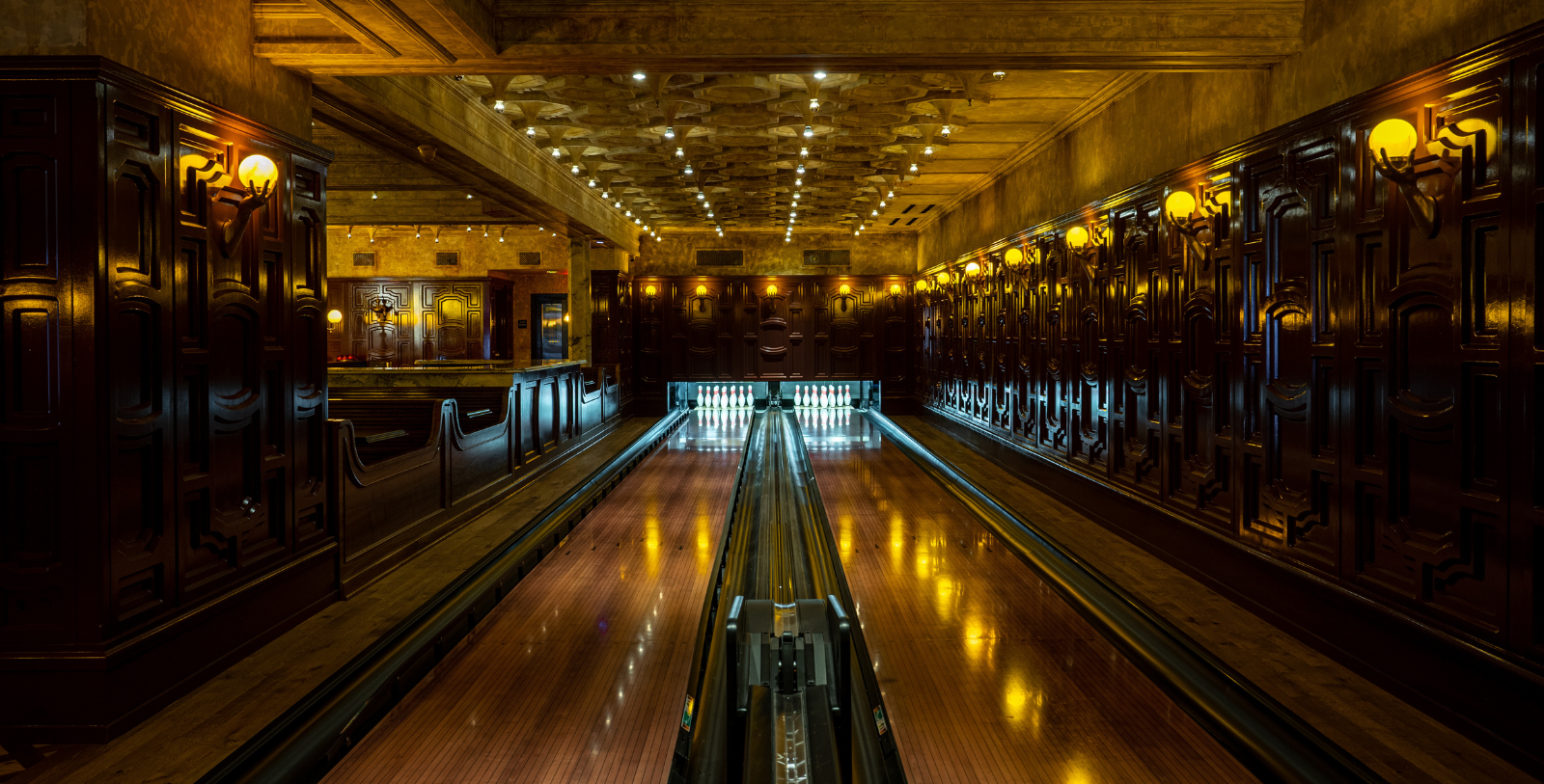 a bowling alley with lights on the ceiling