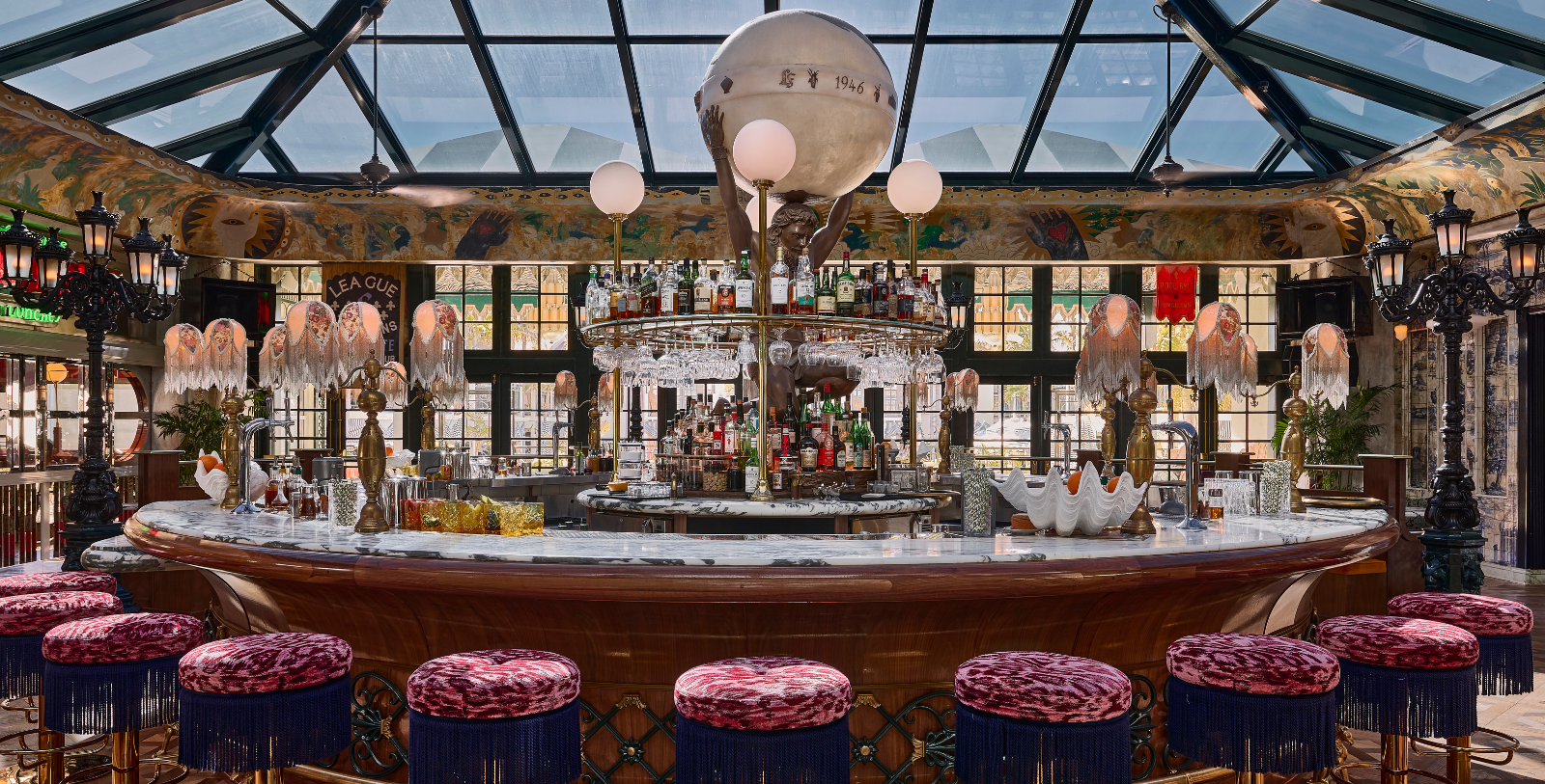 a bar with a round table with a round shelf with bottles on it