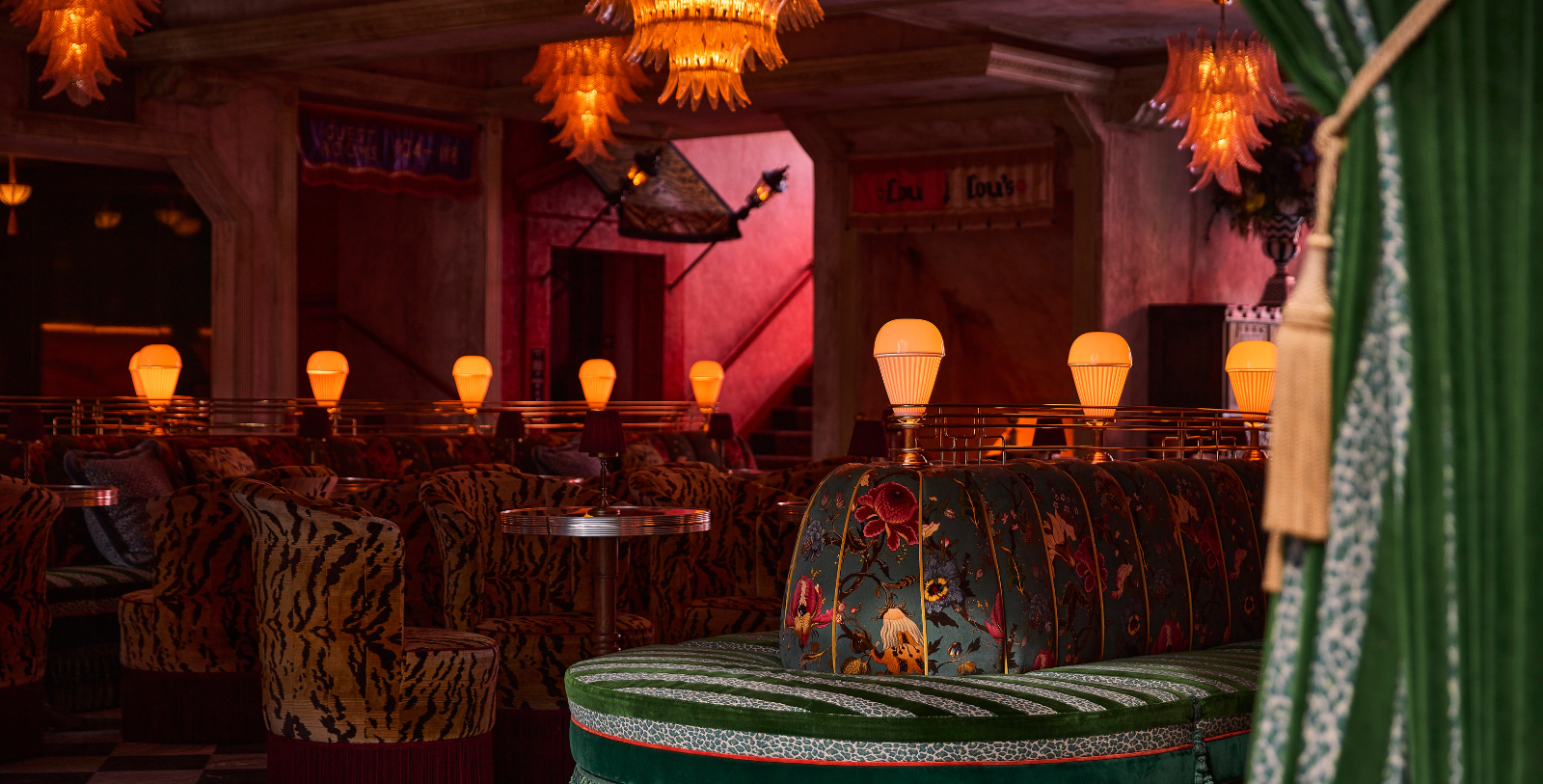 a room with a round table and chairs and lamps