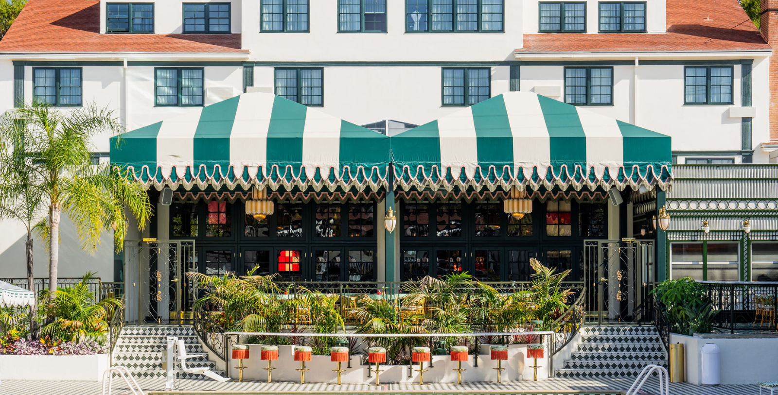 a green and white striped awning in front of a building