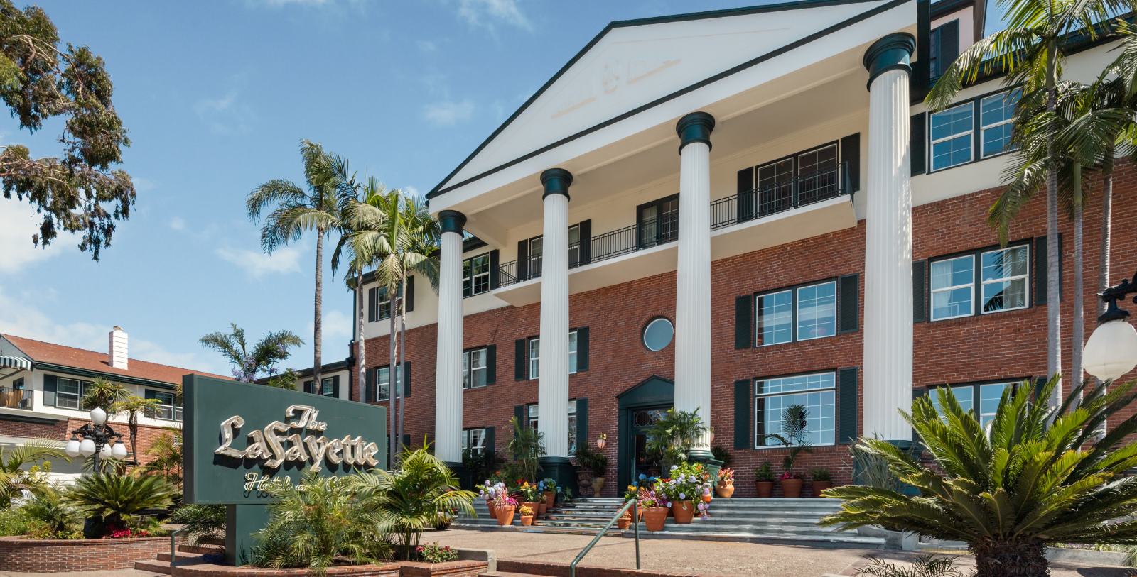 a building with columns and plants
