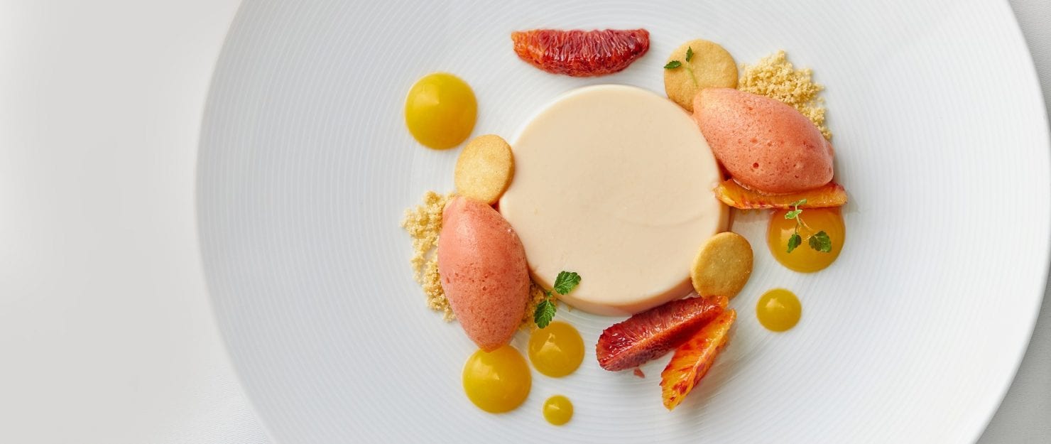 a plate of food with oranges and cookies