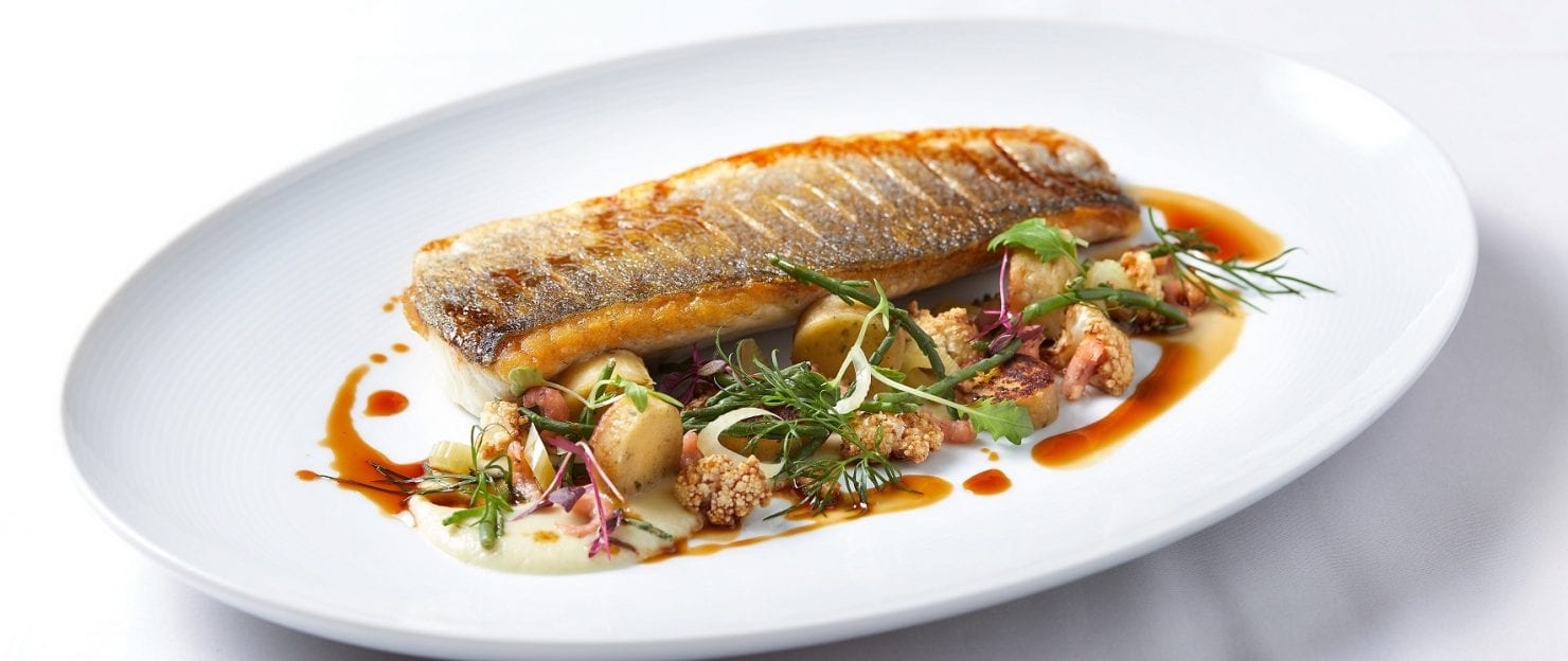 a fish with vegetables on a plate
