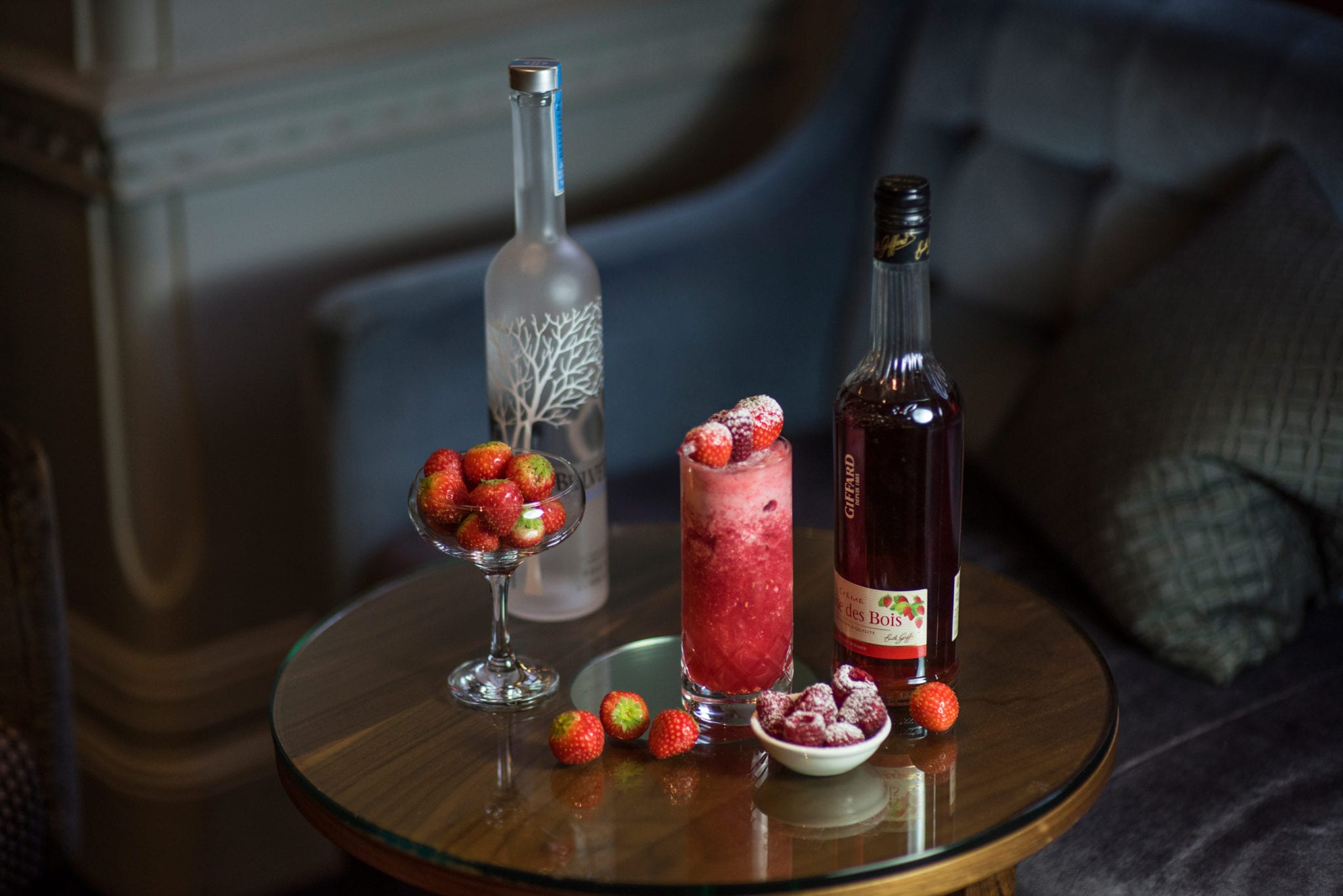 a table with a drink and fruit on it