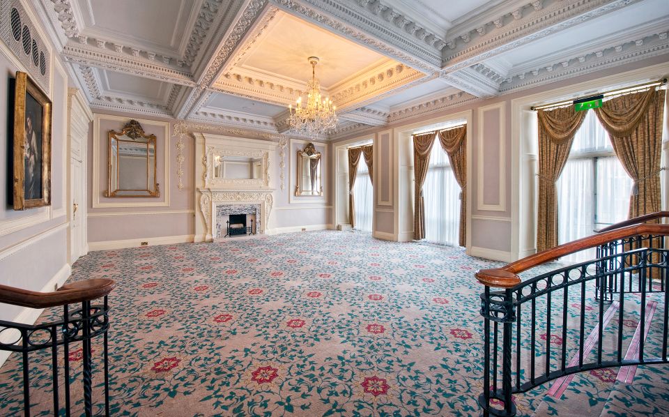 a room with a chandelier and a fireplace
